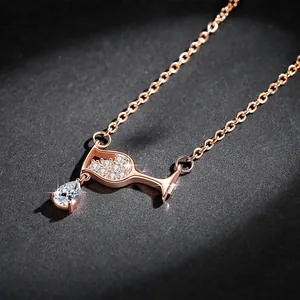 Close-up of rose gold wine glass necklace with sparkling teardrop zircon pendant