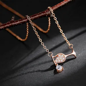 Close-up detail of a rose gold wine glass pendant necklace with sparkling zircons.