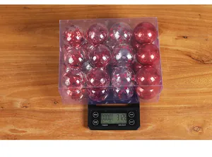 Box of 24 red Christmas ball ornaments 6cm on digital scale showing 312.8g