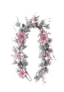 Detailed view of pink Christmas garland with glitter flowers and frosted pine needles