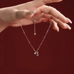 Detailed view of S925 sterling silver necklace with letter J pendant and crystal