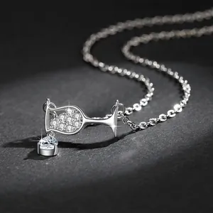 Detailed macro view of silver wine glass pendant necklace with teardrop cubic zirconia