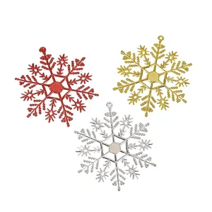 Rote goldene und silberne Glitzer-Weihnachtsschneeflocken für festliche Baumdekoration