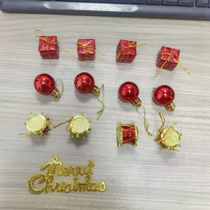 Detalle de varios adornos navideños rojos, cajas de regalo y signo Merry Christmas