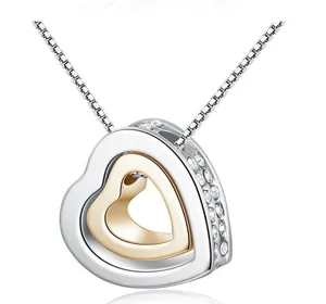 Close-up of double heart pendant necklace with shimmering crystals