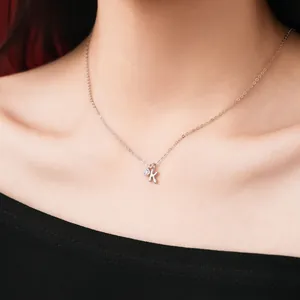 Close-up of S925 sterling silver necklace featuring a letter K and zircon charm