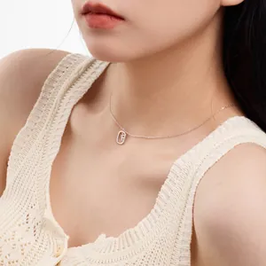 Close-up of S925 sterling silver clavicle chain with dainty hollow initial pendant