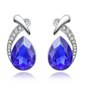 Detail view of silver-tone earrings featuring teardrop blue crystals and zircon accents