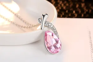 Detailed close-up of a elegant water-drop shaped pink crystal pendant with silver chain