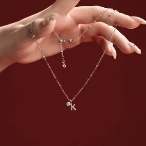 Close-up of S925 sterling silver necklace with a dainty K initial pendant and stone
