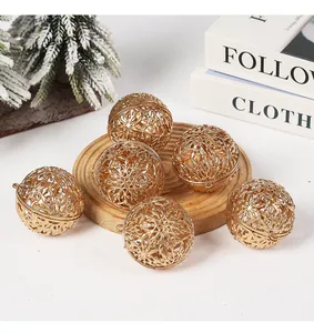 Elegante set di palline di Natale dorate traforate con fiocchi di neve su legno