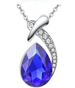 Macro view showing the fine details of a pear-shaped blue crystal necklace with pavé stones