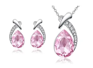 Close-up of pink waterdrop crystal necklace and earrings set with rhinestones