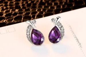 Detail view of elegant purple teardrop crystal stud earrings with rhinestone accents.