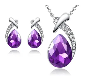 Close-up detail showing the texture of purple teardrop crystal necklace and earrings