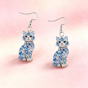 Detailed view of elegant cat drop earrings with blue crystal accents and silver hooks.