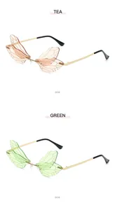 Detailed side view of creative dragonfly wing shaped sunglasses in tea and green