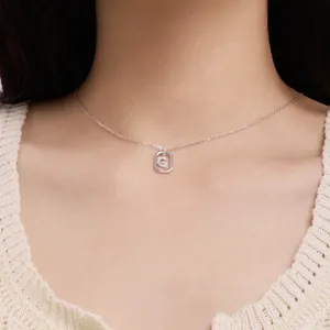 Close-up of S925 sterling silver necklace with crystal-set letter G pendant