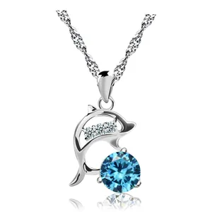 Elegant silver dolphin necklace featuring a large blue round crystal pendant