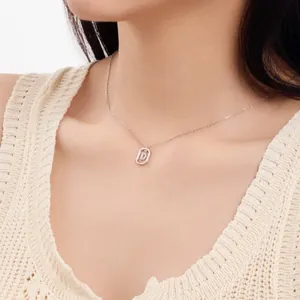Close-up of S925 sterling silver necklace with pavé diamond letter D pendant on model