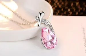 Close-up view of elegant teardrop pink crystal necklace with sparkling stone accents