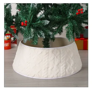 Detail shot of cream white plush Christmas tree collar with elegant knitted cable patterns