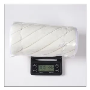 Detailed view of white plush Christmas tree collar being weighed at 356.6 grams