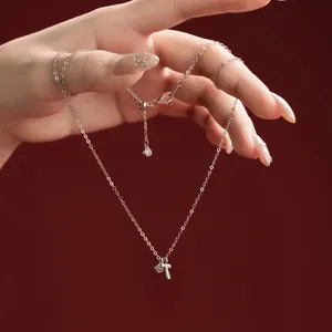 Detail view of an S925 sterling silver necklace with a delicate initial T pendant.