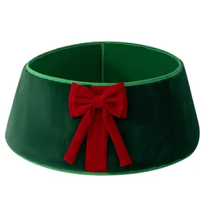 Luxurious green plush Christmas tree collar featuring a festive large red bow decoration