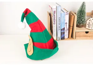 Close-up detail of green and red striped elf hat with cute felt ears for Christmas parties