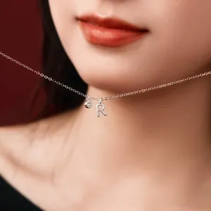 Close-up of S925 sterling silver necklace with letter R pendant and cubic zirconia