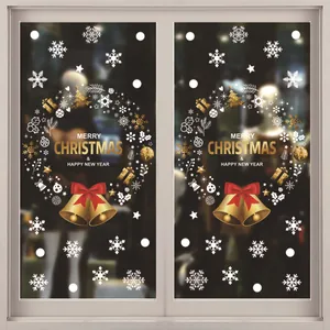 Close-up of festive Christmas wreath window stickers with golden bells and snowflakes.