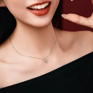 Close-up detail of S925 sterling silver necklace with 'U' initial pendant and crystal stone.