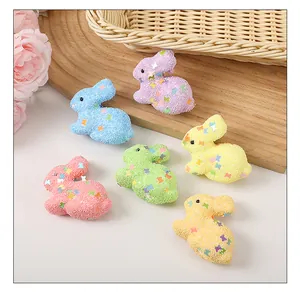 Detailed view of six colorful Easter foam bunnies decorated with sparkling star sequins