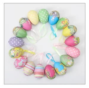 Top view of colorful foam Easter eggs with cute cartoon patterns and hanging ribbons
