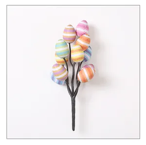 Close-up of festive Easter branch showing detailed colorful striped printed eggs.