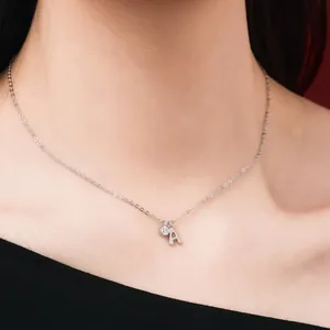 Detailed macro view of an S925 silver necklace with a tiny 'A' initial and crystal pendant.