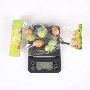 Detail view of colorful Easter egg picks on a digital scale showing 18.6g weight.