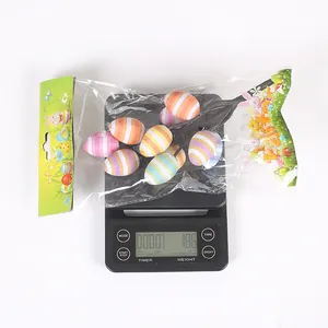 Weight measurement of Easter simulation egg branch decoration on a scale showing 18.6g