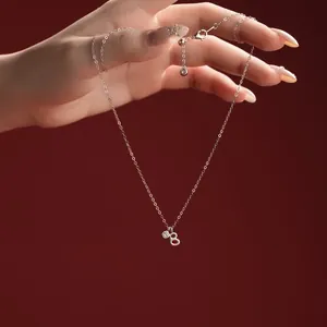 Close-up detail of a delicate S925 sterling silver necklace with letter B pendant