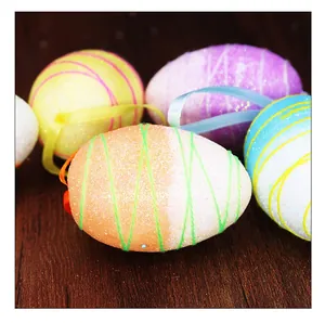 Detailed macro view of colorful glittery Easter foam eggs with hanging silk ribbons