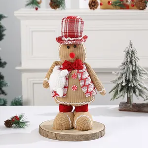 Cozy Christmas knitted snowman doll ornament on a rustic wooden base in a festive room.