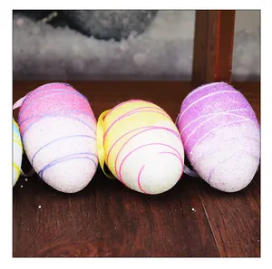 Macro view of colorful Easter foam eggs with glitter finish and decorative thread