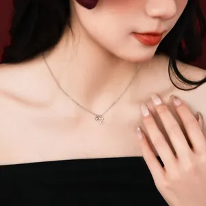 Detail shot of an S925 sterling silver necklace with a tiny Z letter pendant on a model.