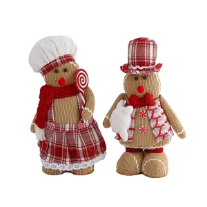 Pair of festive knitted gingerbread dolls for Christmas home and window decorations