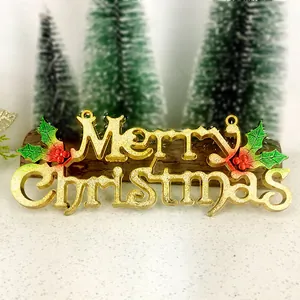Close-up detail of a golden Merry Christmas sign with red berries and green holly