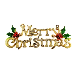 Macro detail of golden glitter Merry Christmas hanging sign with green holly leaves