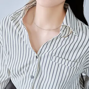 Primer plano de un collar de cadena de bolas de plata de ley S925 en una modelo.