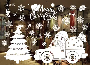 White Christmas window decals with snowflakes and Santa driving a truck