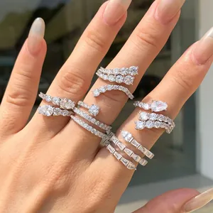 Close-up view of multiple stacked S925 sterling silver rings with cubic zirconia stones